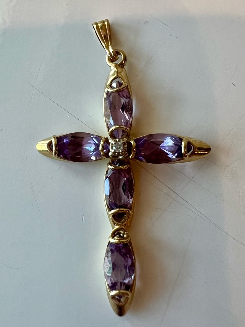 Gold Cross Pendant with Purple Gemstones and Center Accent